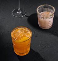 Glasses of cold infused water with fresh orange and iced coffee photo