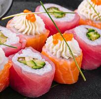 sushi rolls wrapped with salmon and tuna photo