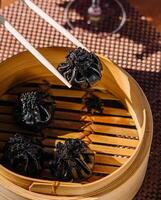 asian dumplings with cuttlefish ink top view photo