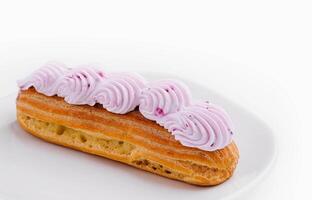 eclair whipped pink cream on plate photo