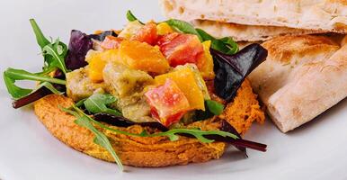 Healthy roasted red pepper hummus and pita bread photo