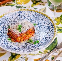 lasagna with and glass of white wine photo