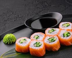 Philadelphia salmon sushi with cucumber inside on plate photo