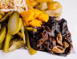 Marinated salty vegetables in the plate photo