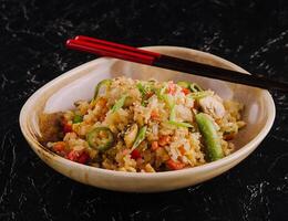 Delicious rice pilaf with vegetables on table photo
