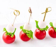 mozzarella with cherry tomatoes on a skewer photo