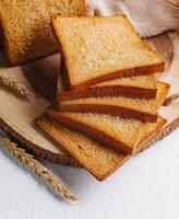 Board with slices of delicious toasted bread photo