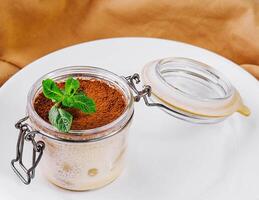 tiramisu in a glass jar top view photo