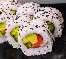 Delicious avocado sushi roll with salmon photo