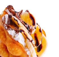 hong kong or bubble waffle with whipped cream, chocolate and bananas photo