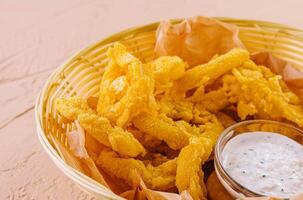 Fried onion rings in white basket photo