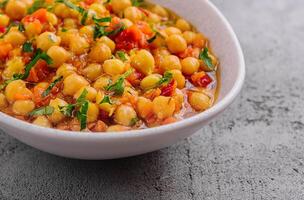 Cooked chickpeas in a white bowl photo