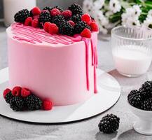 Pink cake with mascarpone cream and fresh berries photo