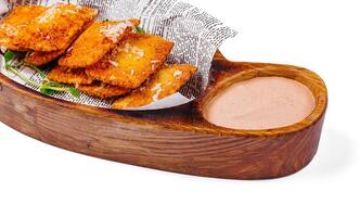 Fried cheese empanadas on wooden board photo