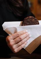 Woman holding Oatmeal Cookies in her hands in coffee shop photo