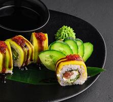 Green dragon sushi roll with eel, avocado, cucumber photo