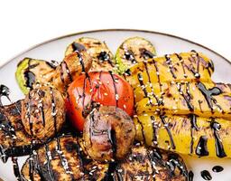 Grilled fresh vegetables on big plate photo