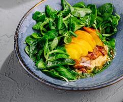 Appetizing pork meat baked with mango and cheese photo