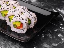 Delicious avocado sushi roll with salmon photo