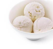 Sweet creamy ice cream in bowl on white photo