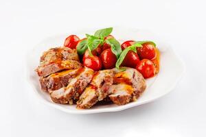 Baked meatloaf with spinach and tomatoes isolated on white photo