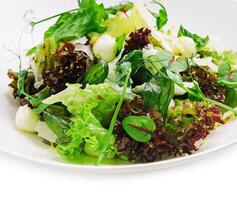 Healthy mozzarella salad on white plate photo