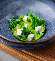 Broccoli, spinach cream soup in a bowl photo