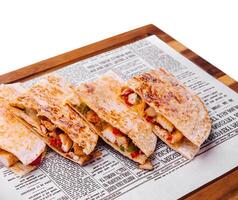 Mexican quesadilla with chicken on wooden board photo