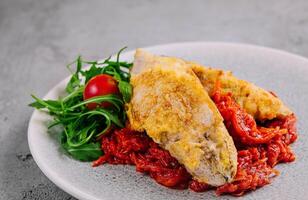 Fried Fish on Vegetable Pillow with Arugula Salad photo