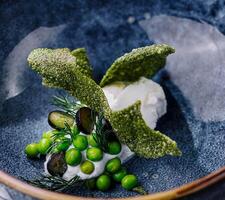 creamy spinach soup with peas top view photo