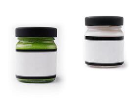 Pesto sauce and cream sauce in a glasses jars isolated photo