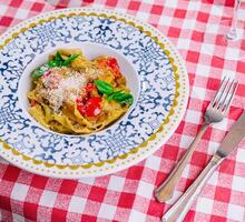 Italian pasta with tomatoes, parmesan and basil photo