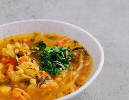 Vegetable soup on stone, top view photo