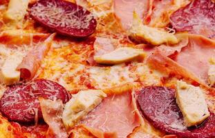 Pepperoni Pizza with Mozzarella cheese, salami, ham photo