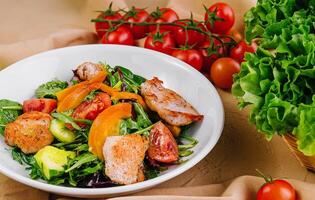 Healthy fresh chicken salad with vegetables photo