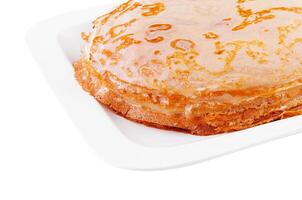Tasty thin pancake on white plate photo