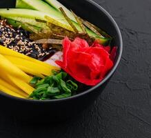 bowl with mango, cucumber and eel in unagi sauce photo
