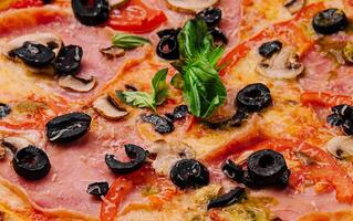 Appetizing sicilian pizza with ham and black olives photo
