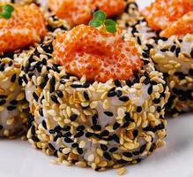 sushi rolls with salmon pieces and red caviar photo