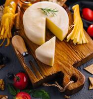 Cheese plate with variety of cheese top view photo