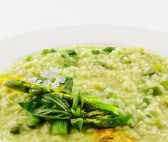 Dish of risotto with asparagus isolated on white plane photo