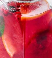 Strawberry, orange and basil sparkling punch, spring cocktail photo