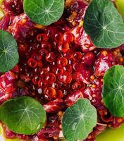 Tuna tartar with red caviar close up photo