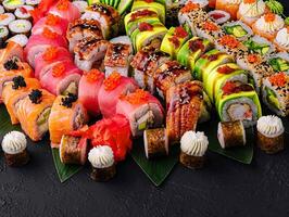 Large sushi set, shot from the top on a black background photo