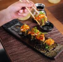 girl eats Japanese sushi gunkan salmon photo