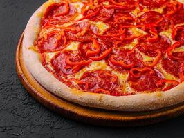 tasty pepperoni pizza with red bell peper photo