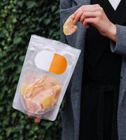 Girl Eating Dried Mango Slices photo