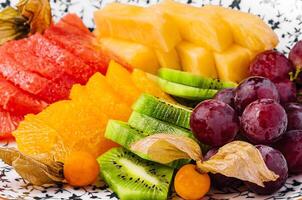 kiwi smoothie with different tropical fruits on a plate photo