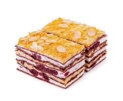 two slices of multilayer cocoa sponge cake with almonds photo