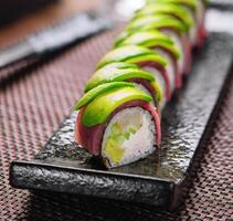 sushi rolls wrapped with tuna and avocado photo